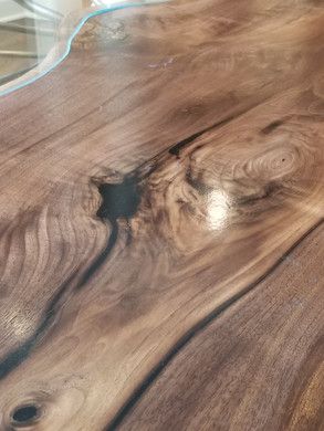 A close up of a wooden table with a hole in the middle.