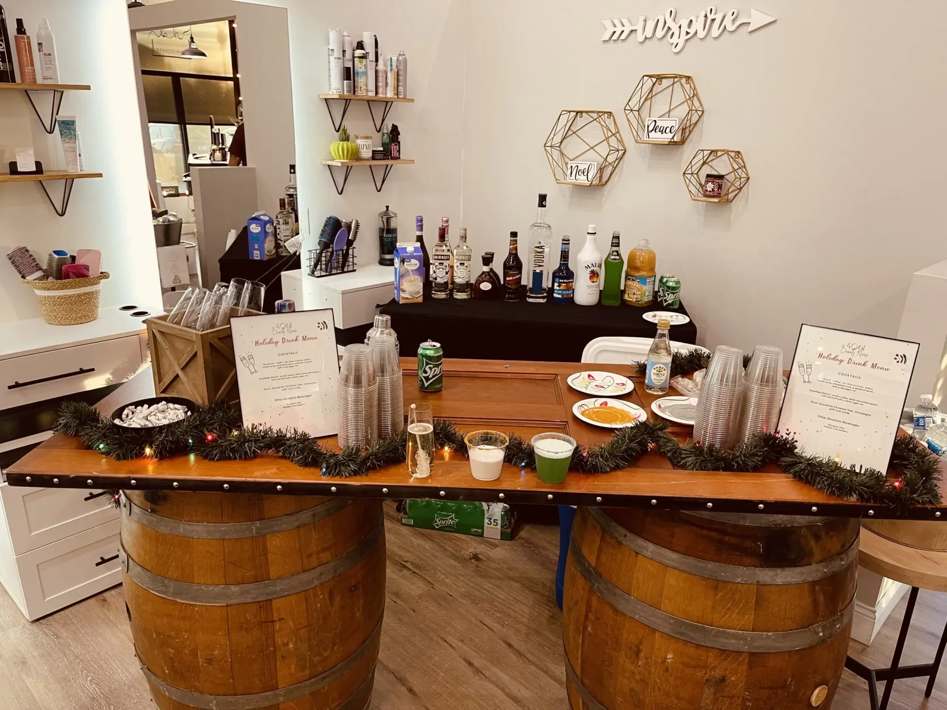 Two wooden barrels are sitting next to a wooden table in a room.
