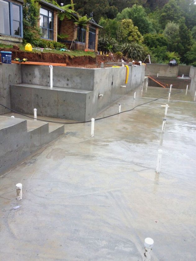 Residential property with a newly poured driveway and tradesperson's ute