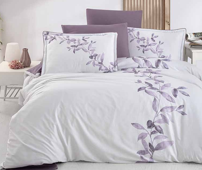 White bedding with purple leaf design, including pillows and duvet.