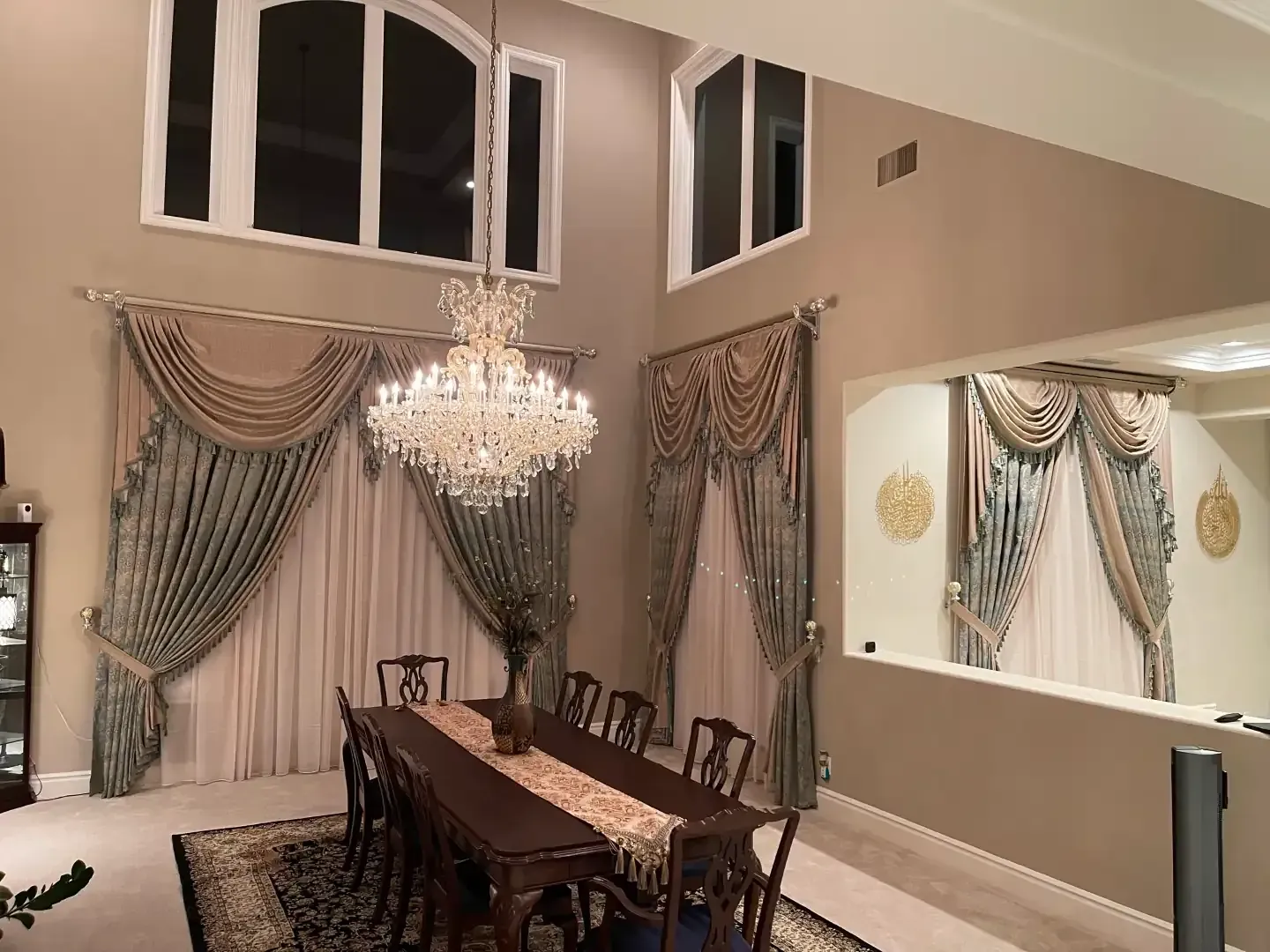 A dining room with a table and chairs and a chandelier