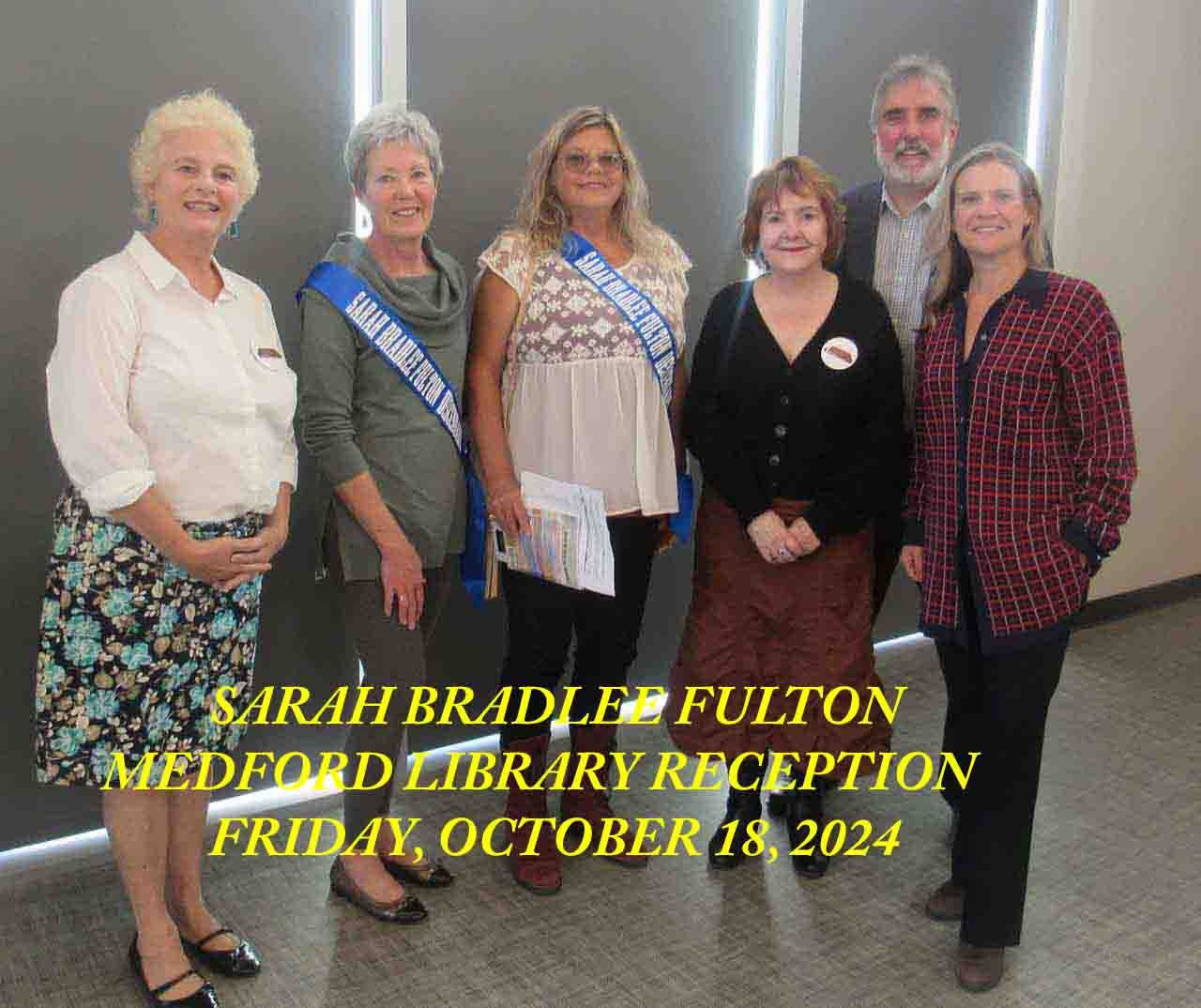 Group of people at library reception; text: 