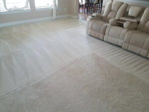 A living room with a couch and chairs and a carpeted floor.