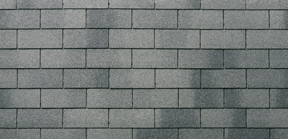 Bardeaux de toiture en asphalte gris, disposés en motif de briques.