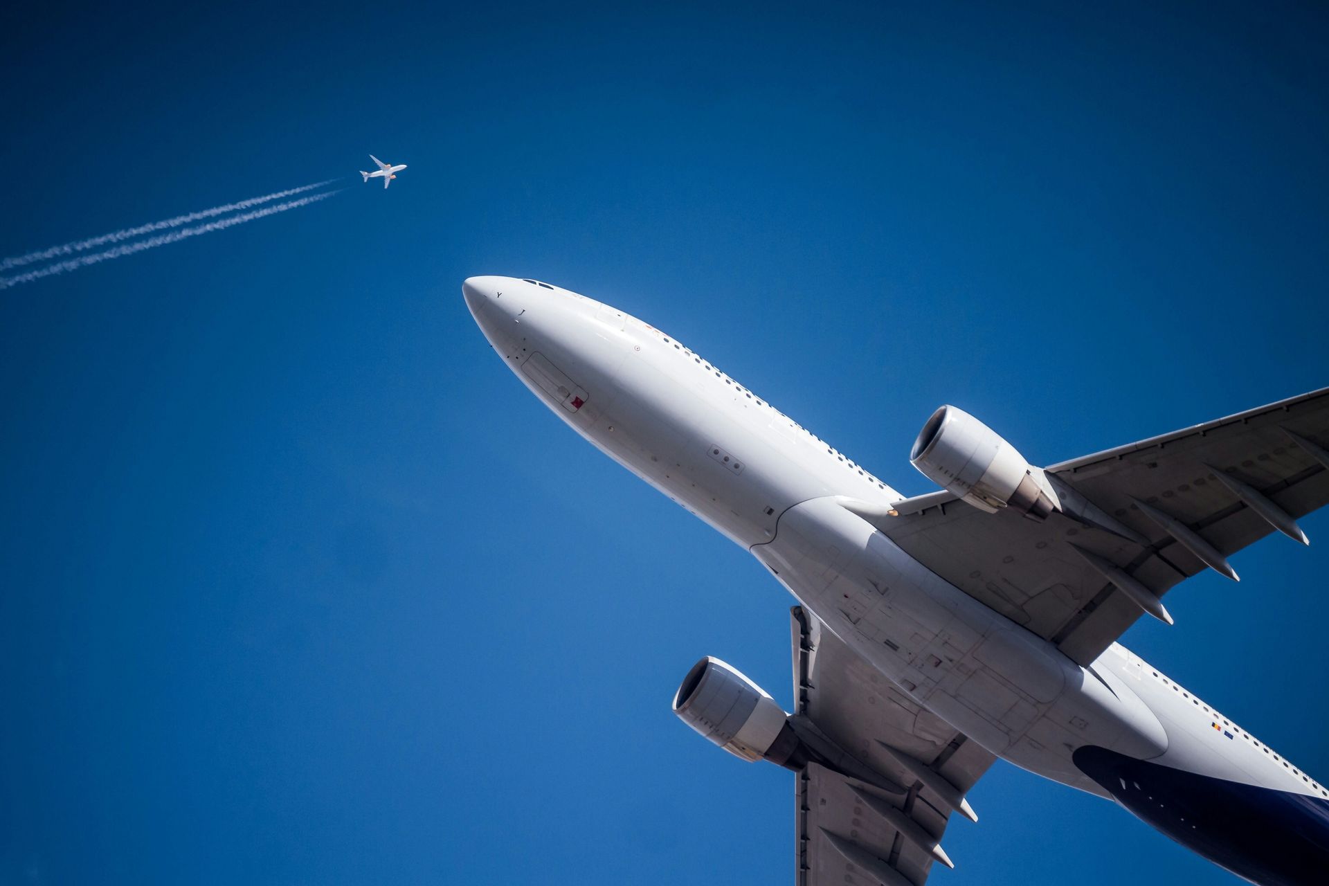 Commercial aircraft in flight representing aerospace-grade components and finishing quality