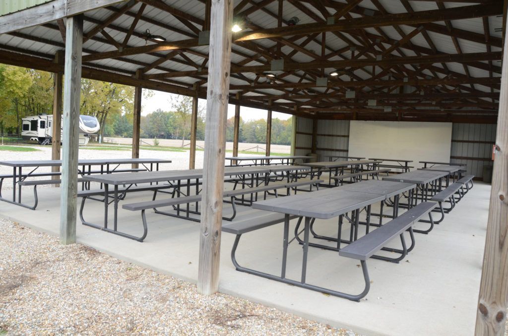 A pavilion with tables and benches under a roof