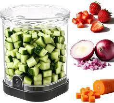 Image of simple push chopper filled with vegetables that have been cut into small pieces.