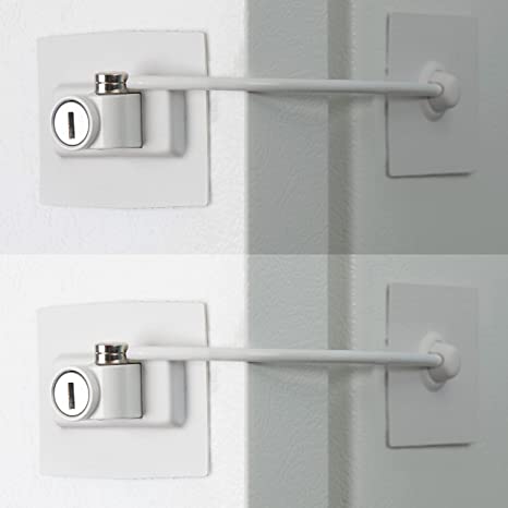 White child safety lock installed on a refrigerator door, allowing only partial opening.