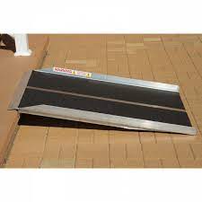 Aluminum ramp on brick surface.