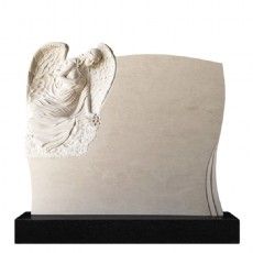 Ein Grabstein mit einer Engelsstatue darauf.