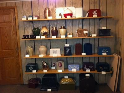 Shelves of assorted decorative items and bags against a wood-paneled wall