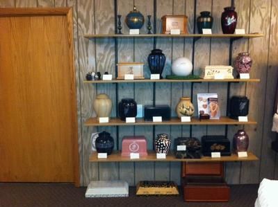 Wall shelves with decorative vases, bowls, and ornaments beside a wooden sliding door.