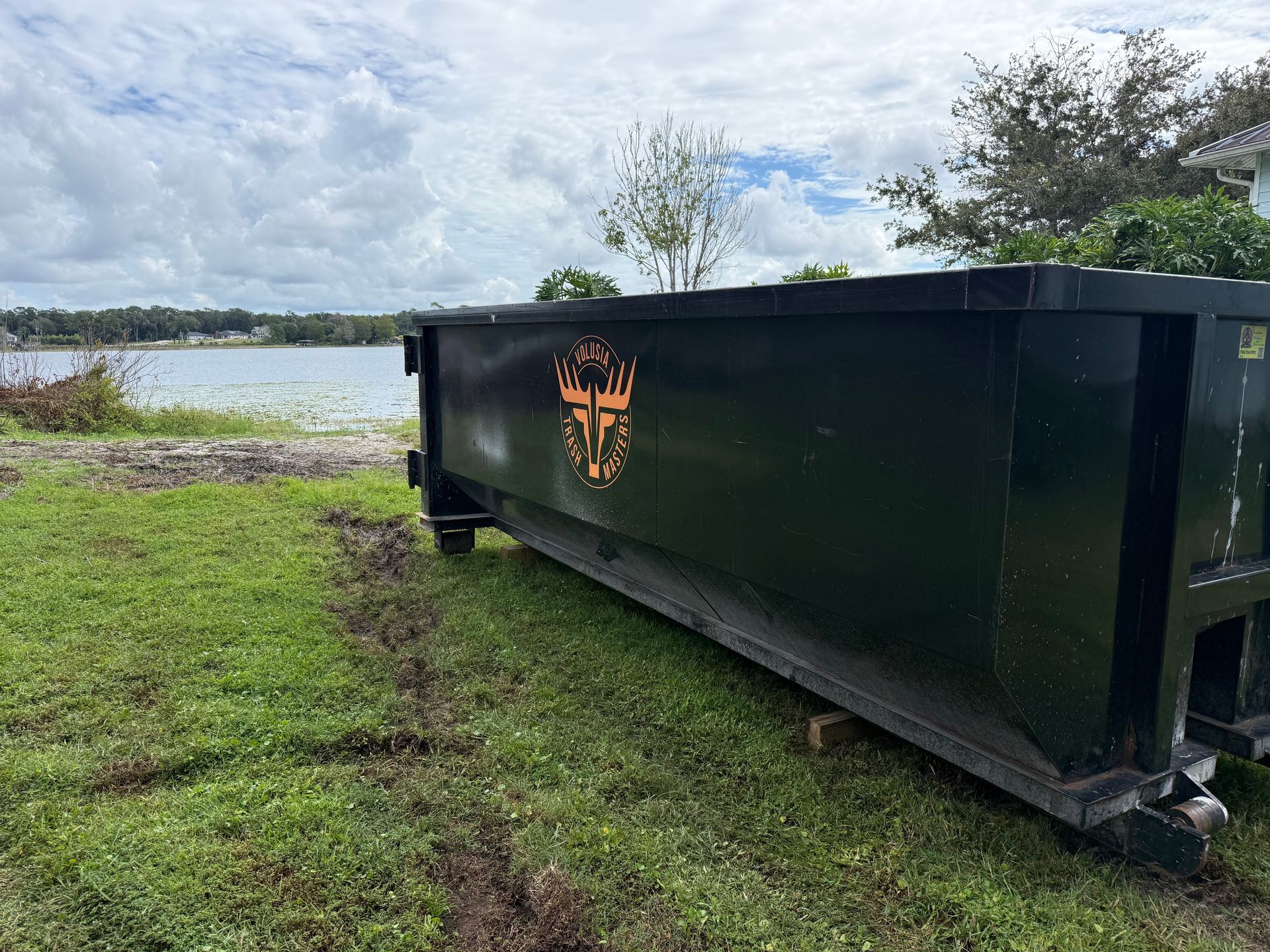 Volusia Trash Masters 20-yard roll-off dumpster at a residential property in Volusia County, Florida.