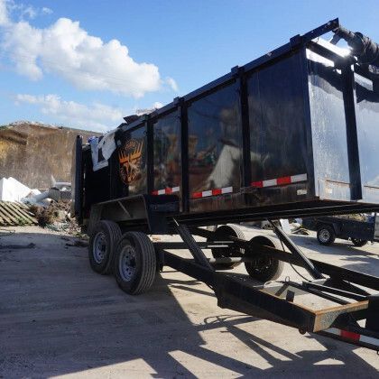 A dumpster is sitting on a trailer in a parking lot