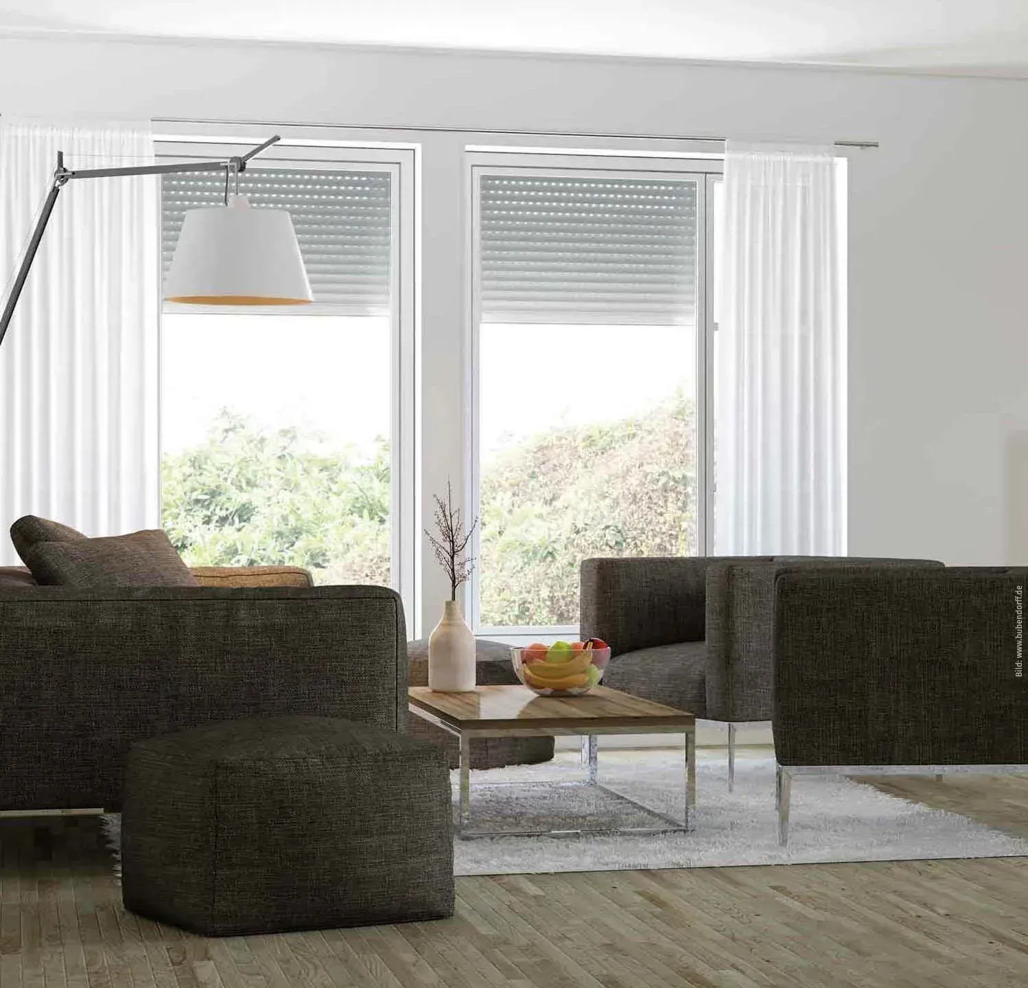 Ein Wohnzimmer mit einer Couch, zwei Sesseln, einem Couchtisch und einer Lampe. Bild von Bubendorff