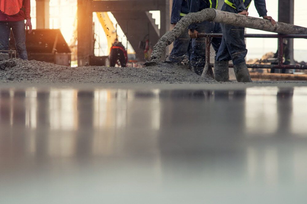 A Group Of Construction Workers Are Pumping Concrete — Regional Concreting Solutions In Bathurst, NSW