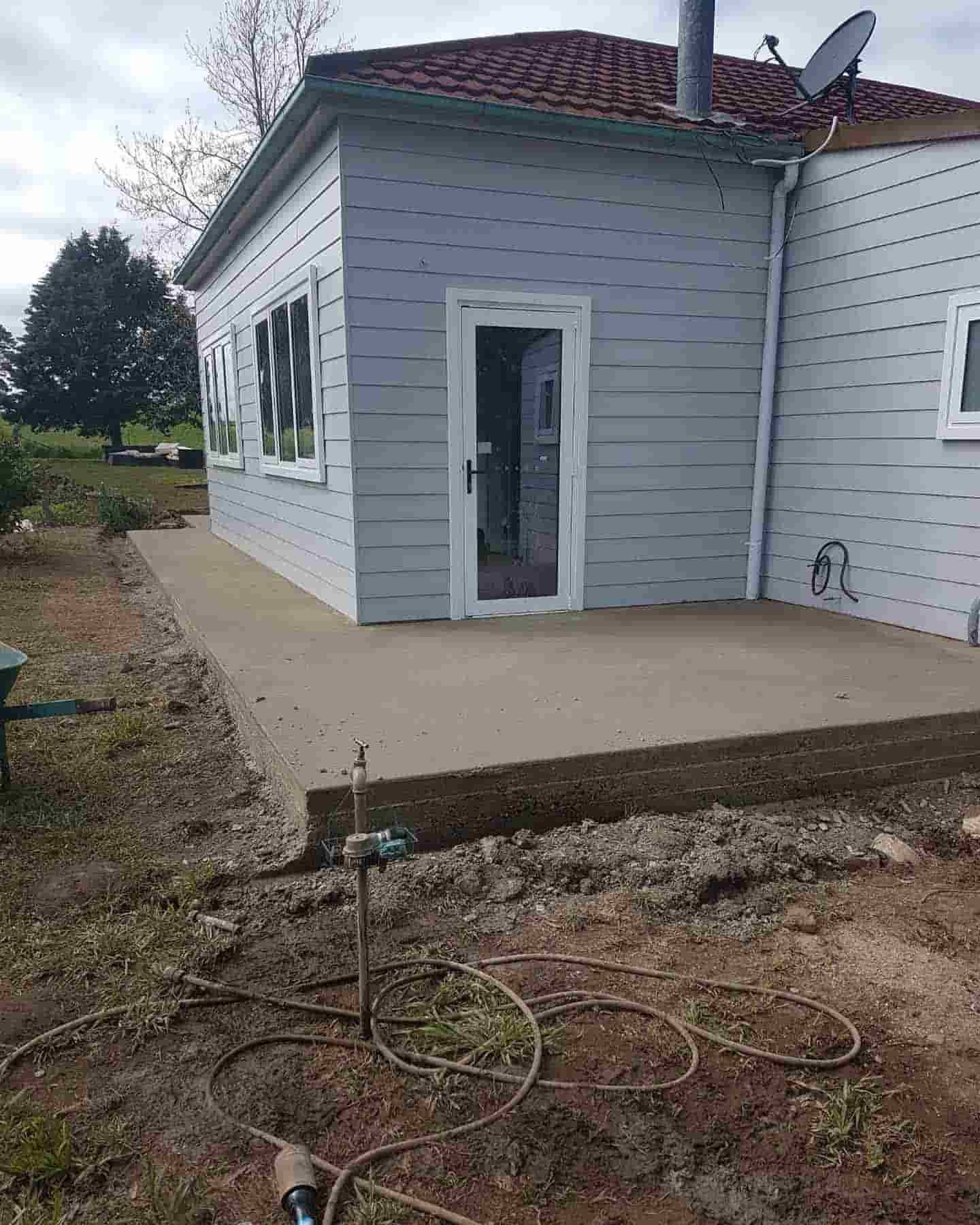 A Small White House With A Patio In Front Of It — Regional Concreting Solutions In Bathurst, NSW