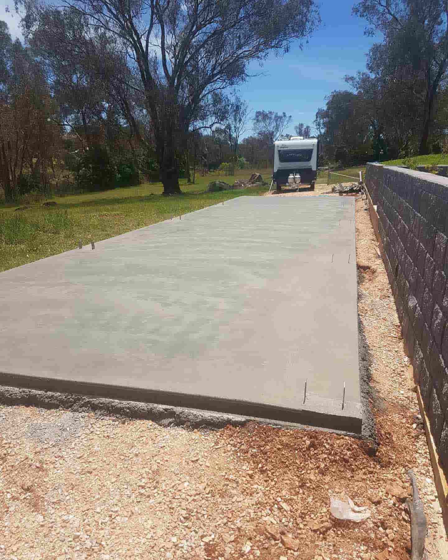 A Concrete Driveway With A Camper Parked On The Side Of It — Regional Concreting Solutions In Cudal, NSW
