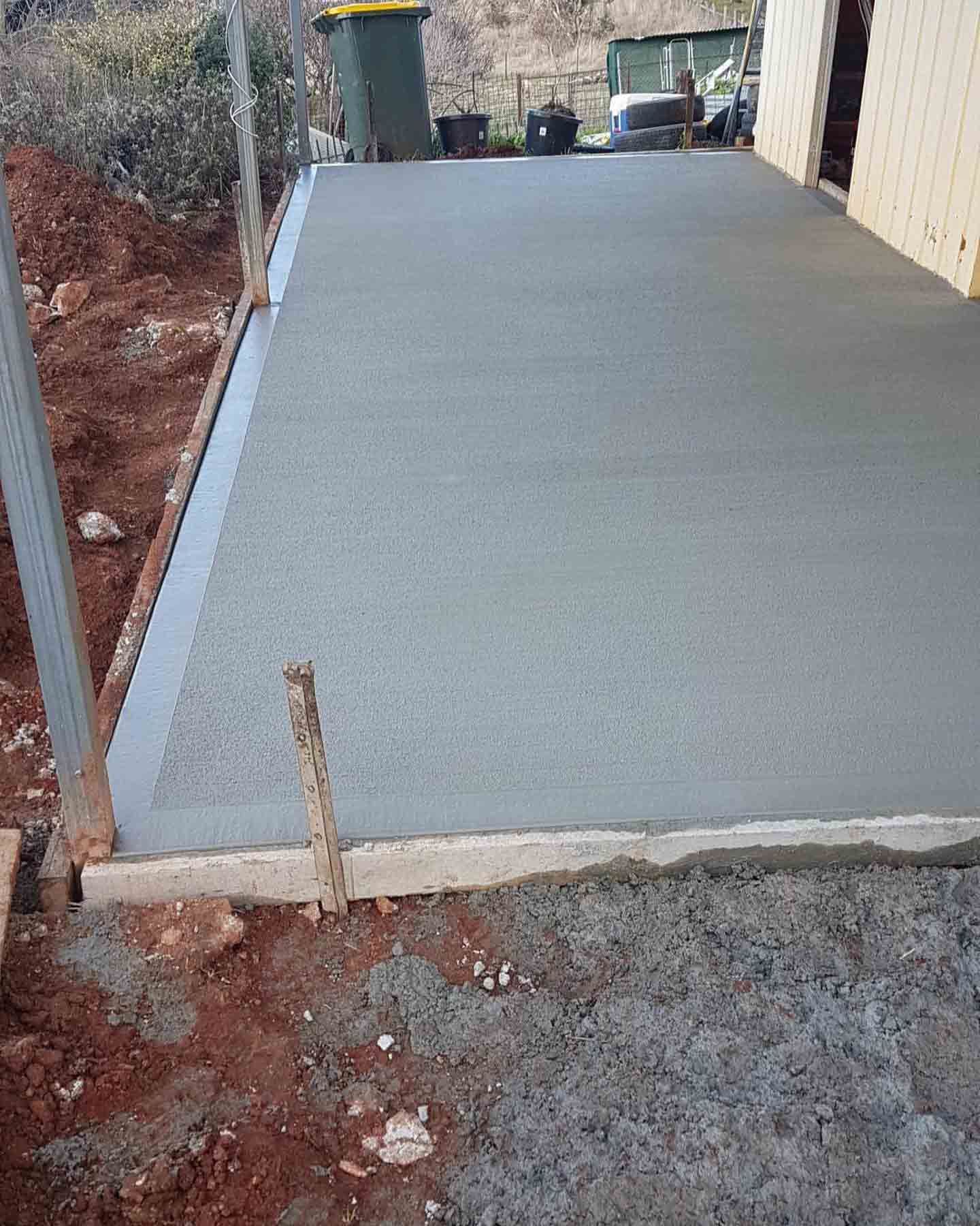 A Concrete Driveway Is Being Built In Front Of A House — Regional Concreting Solutions In Cudal, NSW