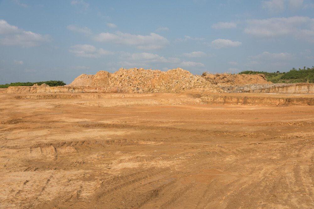 A Large Pile Of Dirt Is Sitting In The Middle Of A Dirt Field — Regional Concreting Solutions In Blayney, NSW