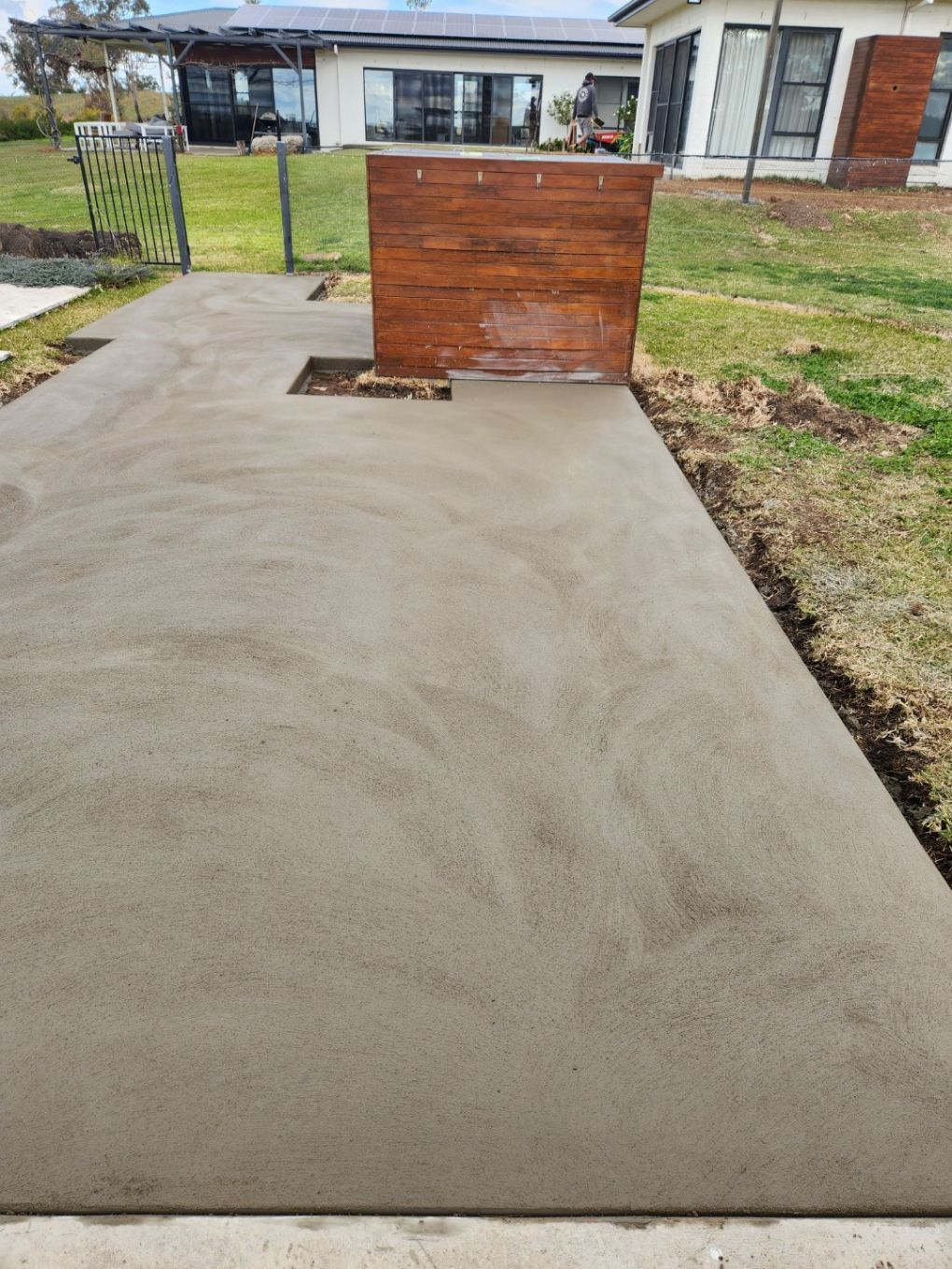 A Metal Ring Is Sitting In The Middle Of A Hole In The Ground — Regional Concreting Solutions In Bathurst, NSW