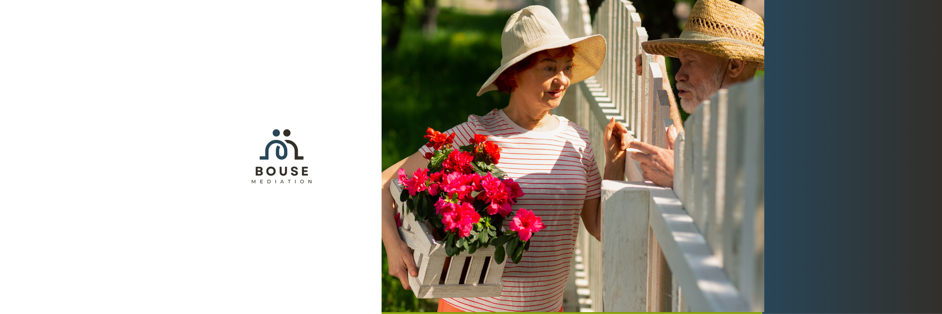 Person in a sunhat holding a bright red flower bouquet on a balcony beside white flowers.