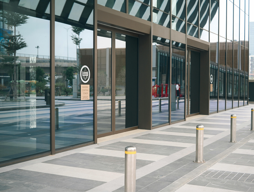 a modern building with glass storefronts and a paved walkway. a modern building with glass storefronts and a paved walkway.
