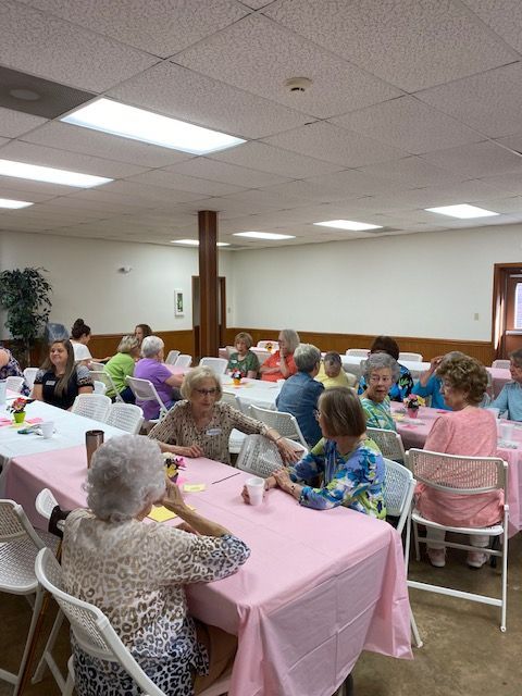 A group of people are sitting at tables in a room.