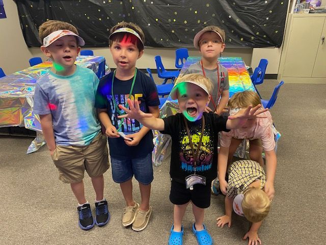 A group of young boys are posing for a picture in a room.