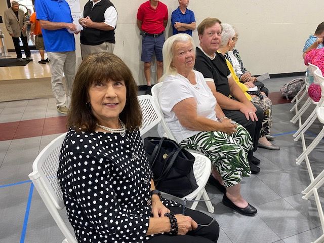 A group of people are sitting in chairs in a room.