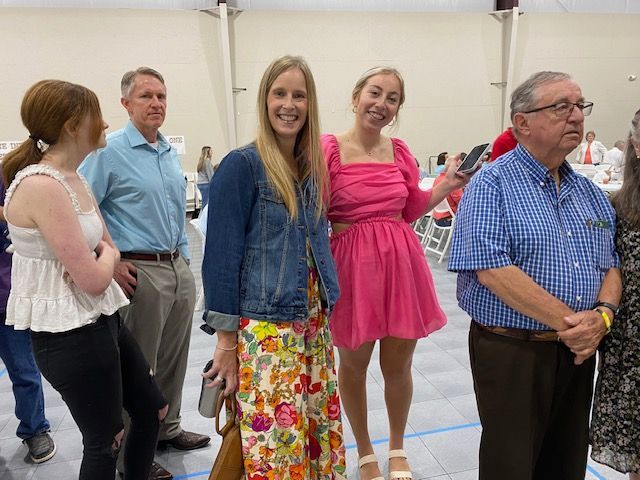 A group of people standing next to each other in a room.