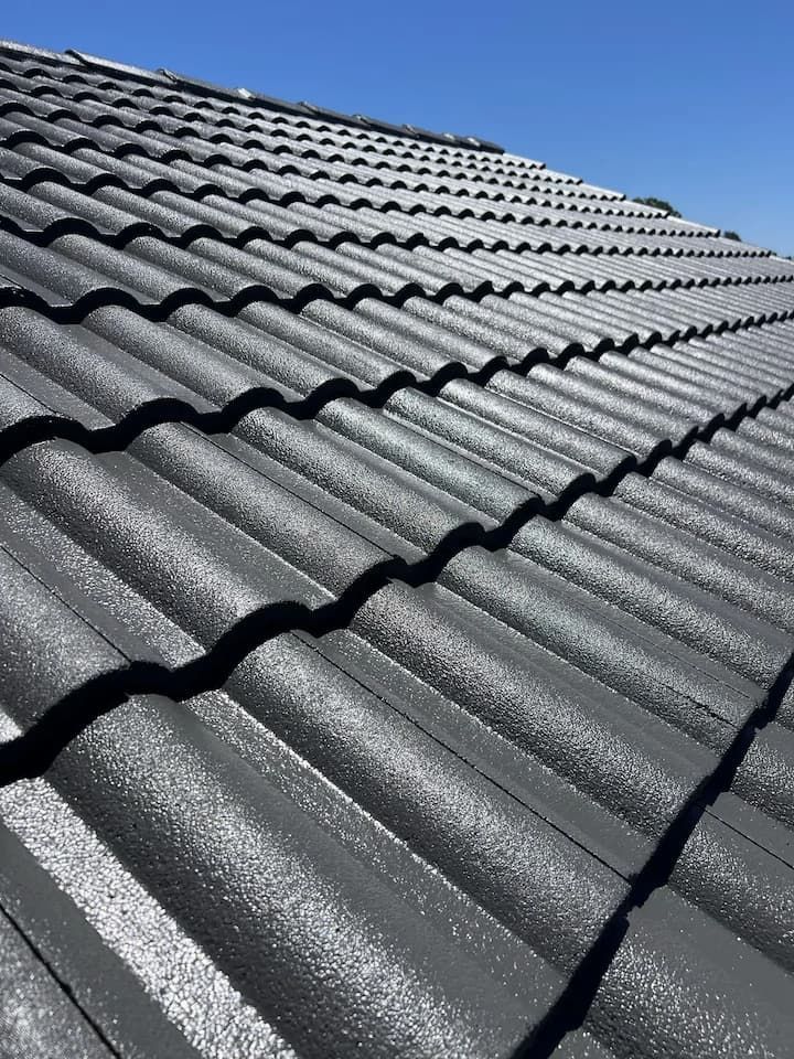 Close-up of a gray tiled roof under a clear blue sky