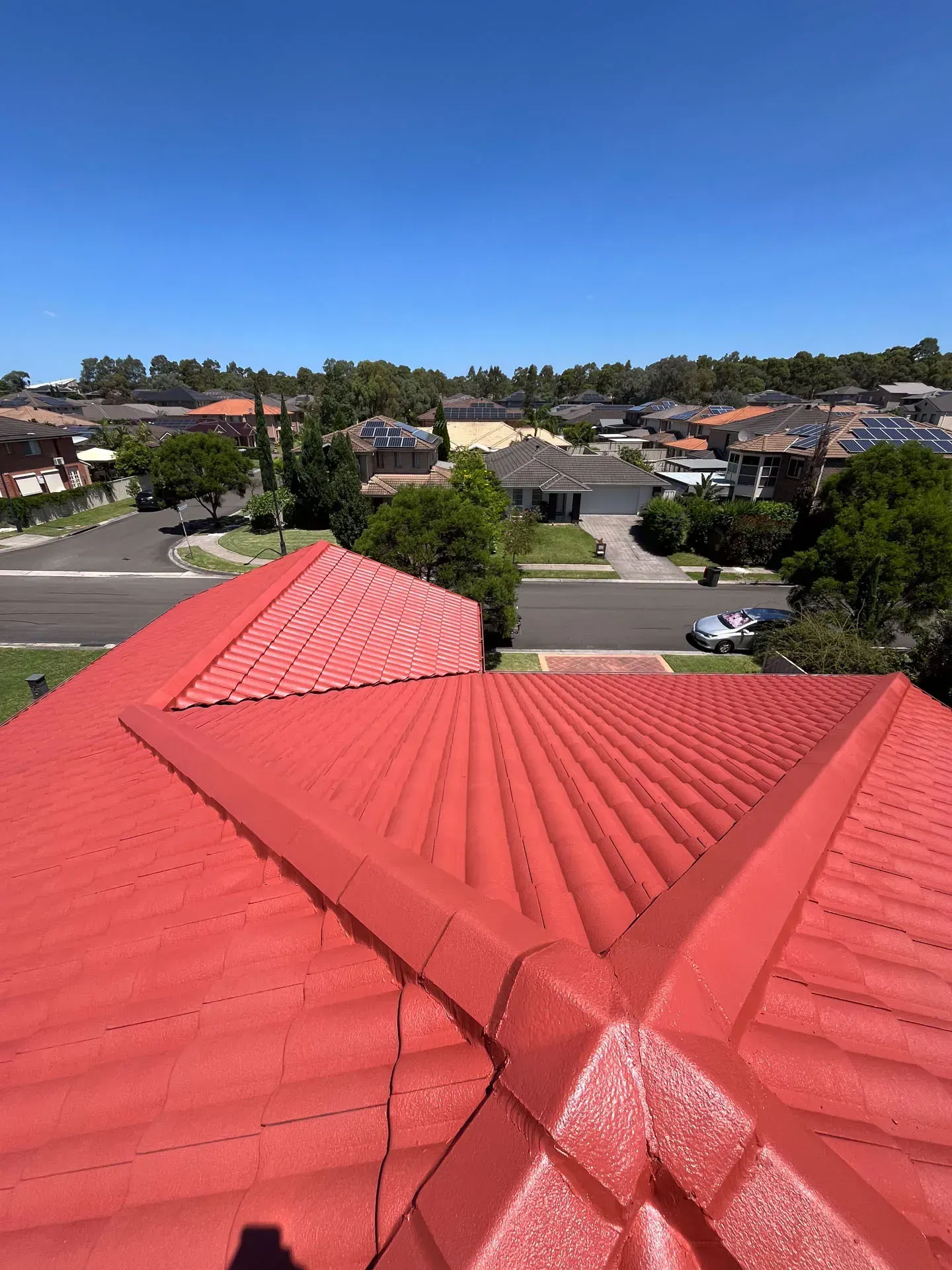 A red roof with a view of a residential area