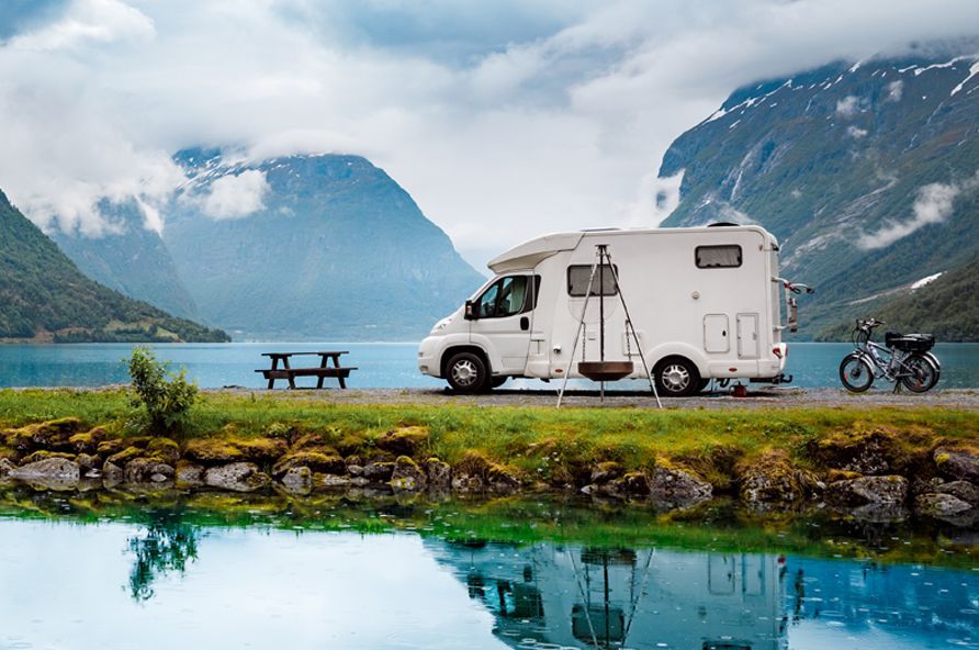 RV and motorcycle overlook a lake looking for recreation fun