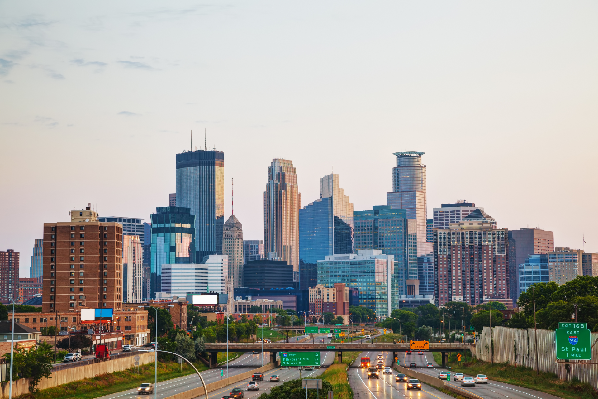 A city skyline with a bridge and an american flag in the foreground.