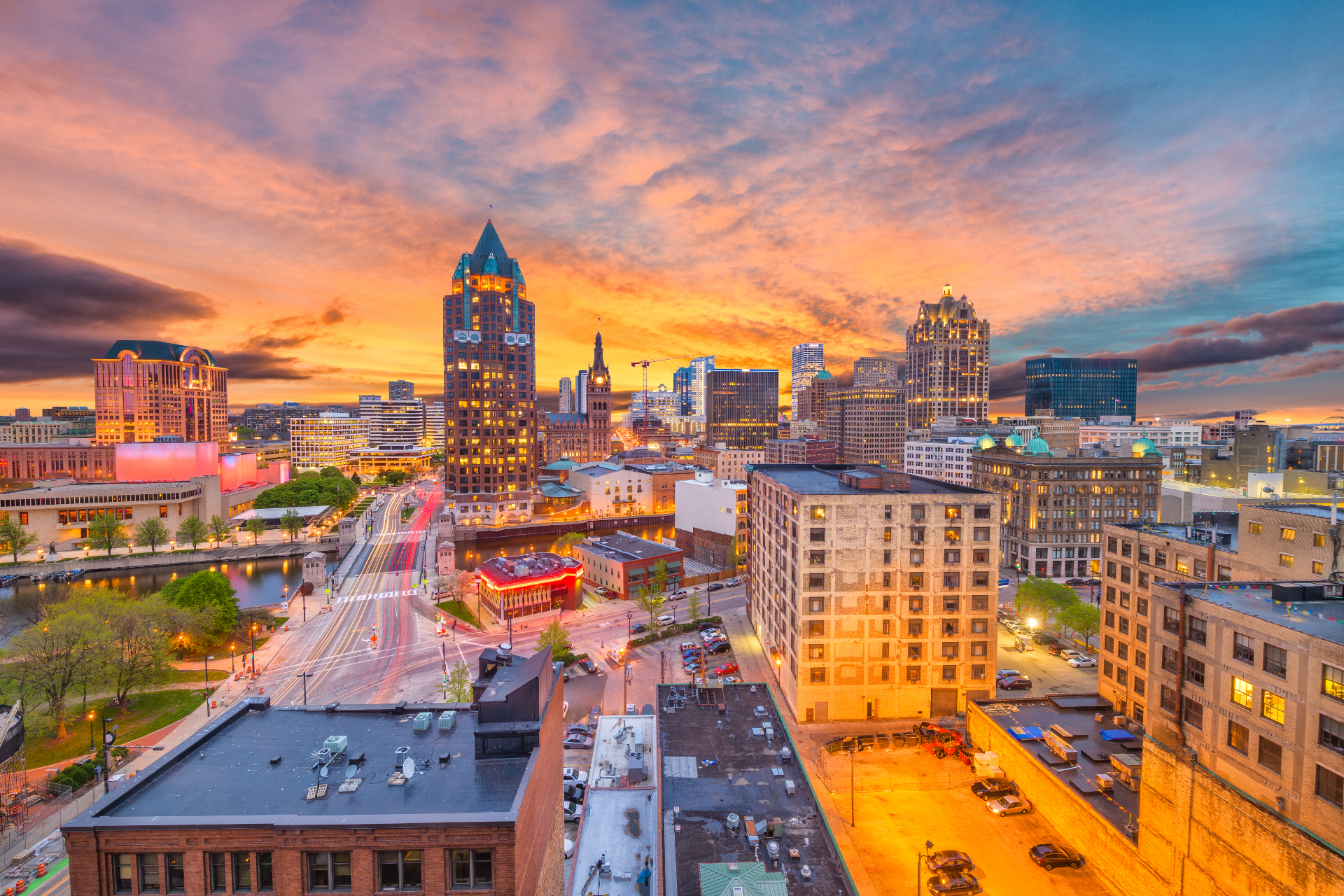 A city skyline with a bridge and an american flag in the foreground.