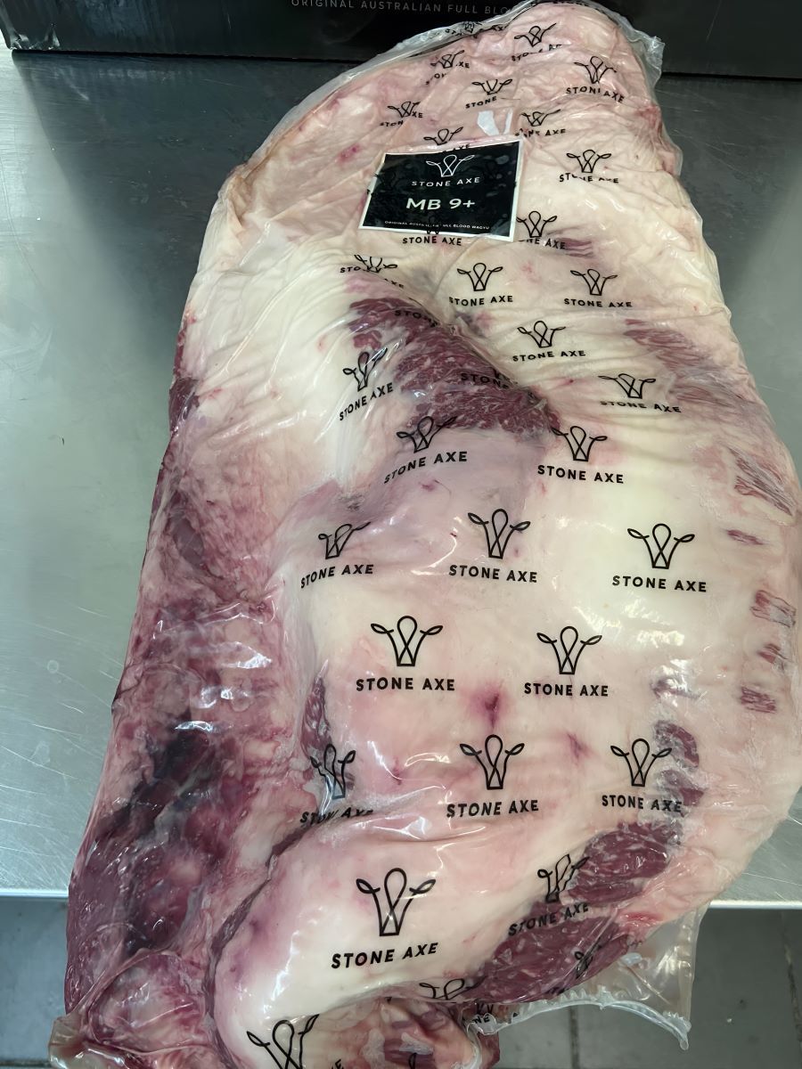 A Large Piece of Meat is Wrapped in Plastic and Sitting on a Table — Prime Meats NT in Coconut Grove, NT