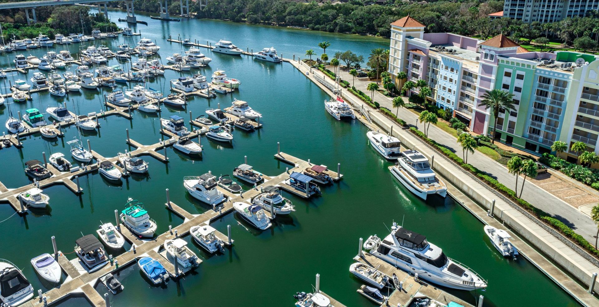 An aerial view of a marina filled with boats and buildings.