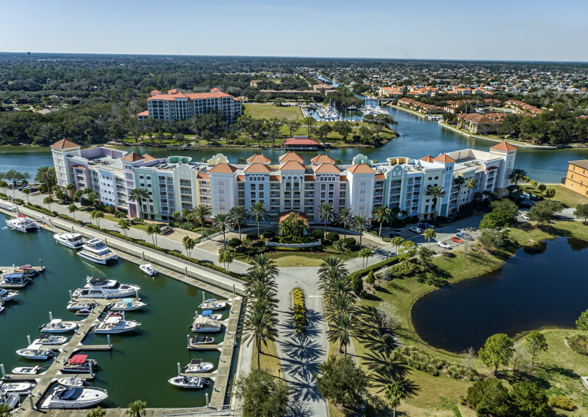 An aerial view of a marina filled with boats and buildings.