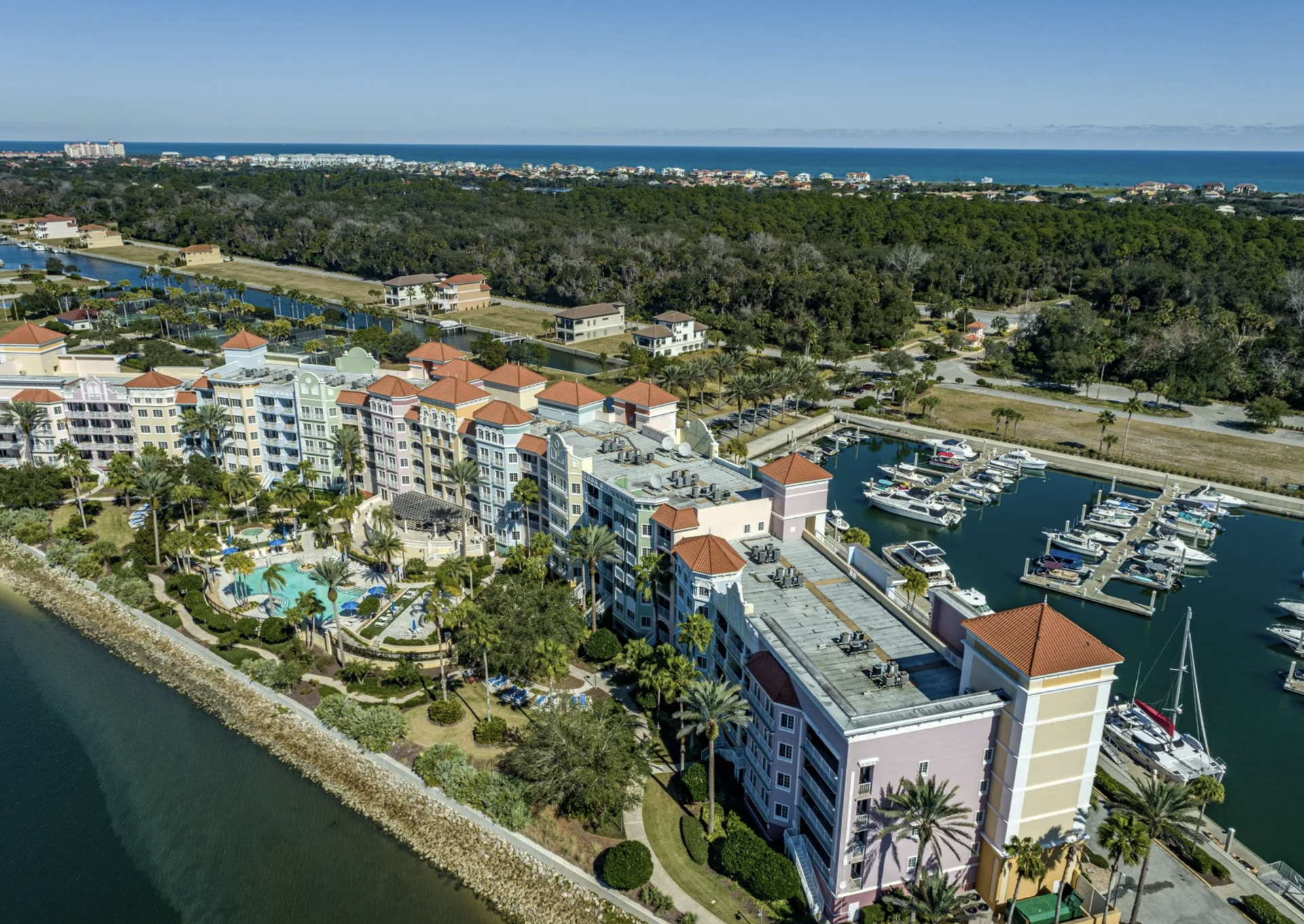 An aerial view of a resort with boats docked in the water.