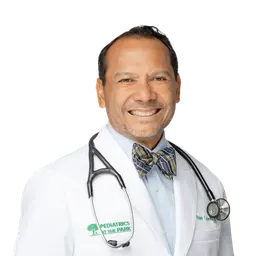 Smiling doctor in a white coat with a stethoscope and bow tie on a white background