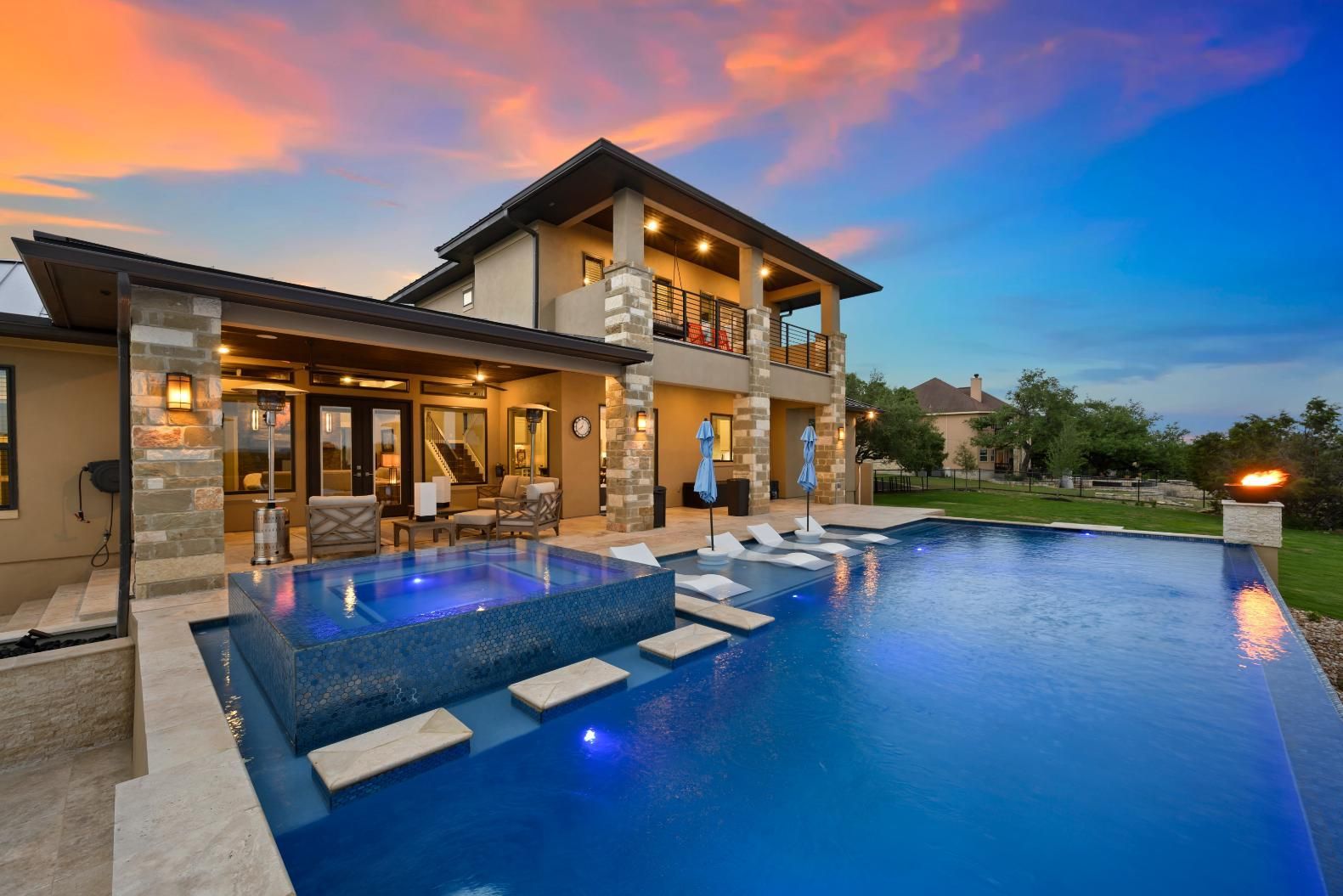 A Large House With A Swimming Pool In Front Of It — Yamba Pools & Spas In Yamba, NSW