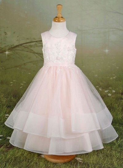 Pink layered sleeveless dress on a mannequin against a green backdrop.
