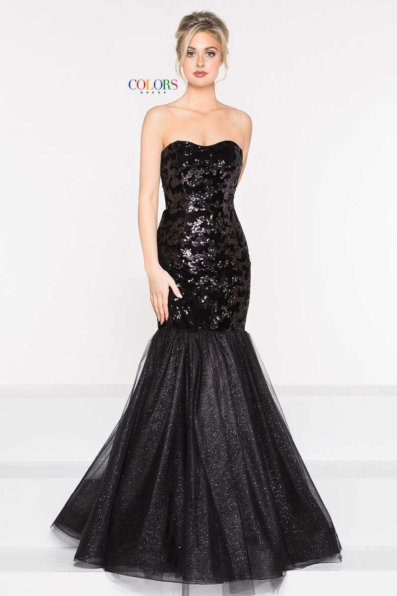 Woman in a strapless black sequined mermaid gown standing against a white backdrop.