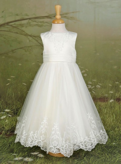 White sleeveless tulle dress on a mannequin against a muted green background