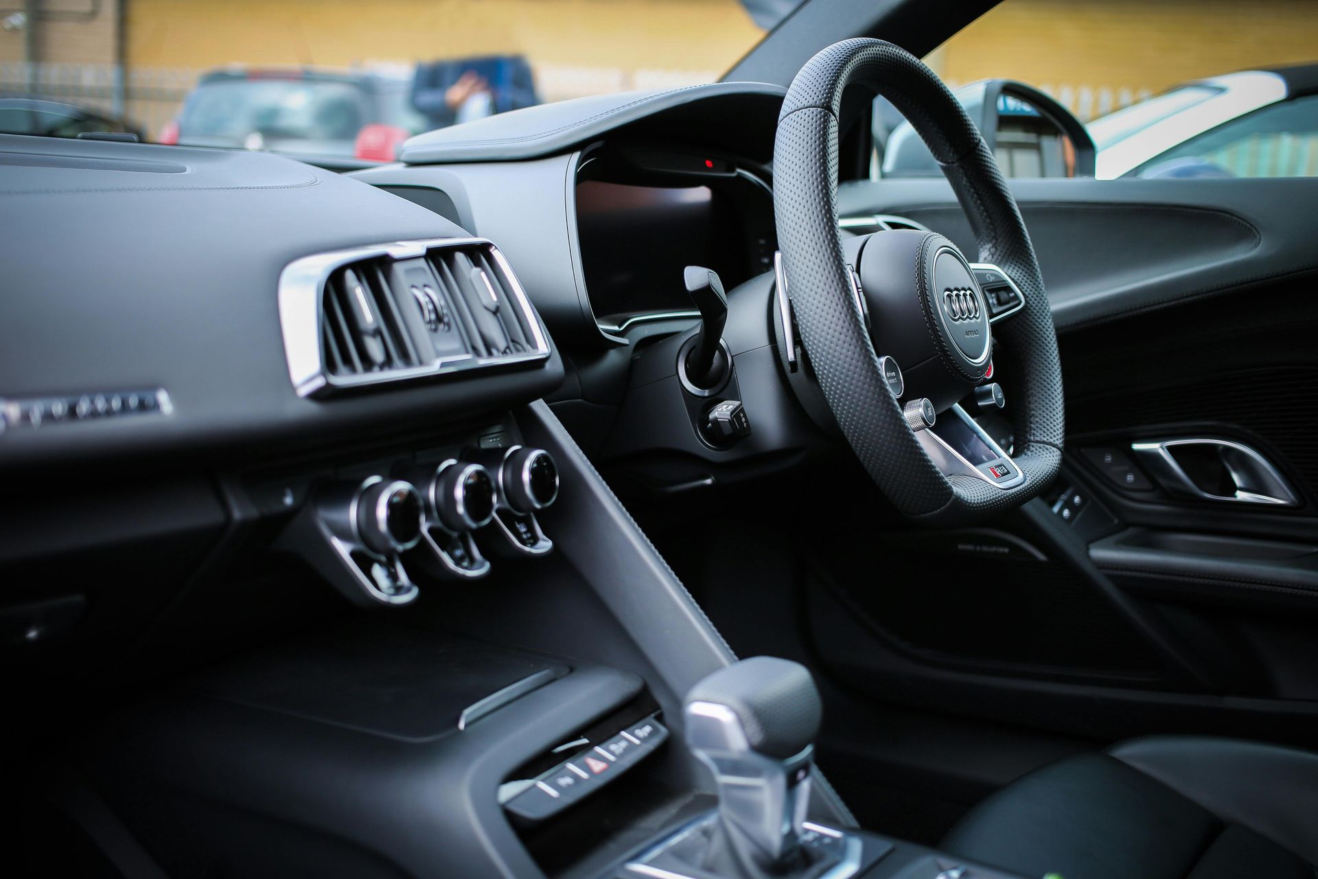 A close up of the interior of a car with a steering wheel.