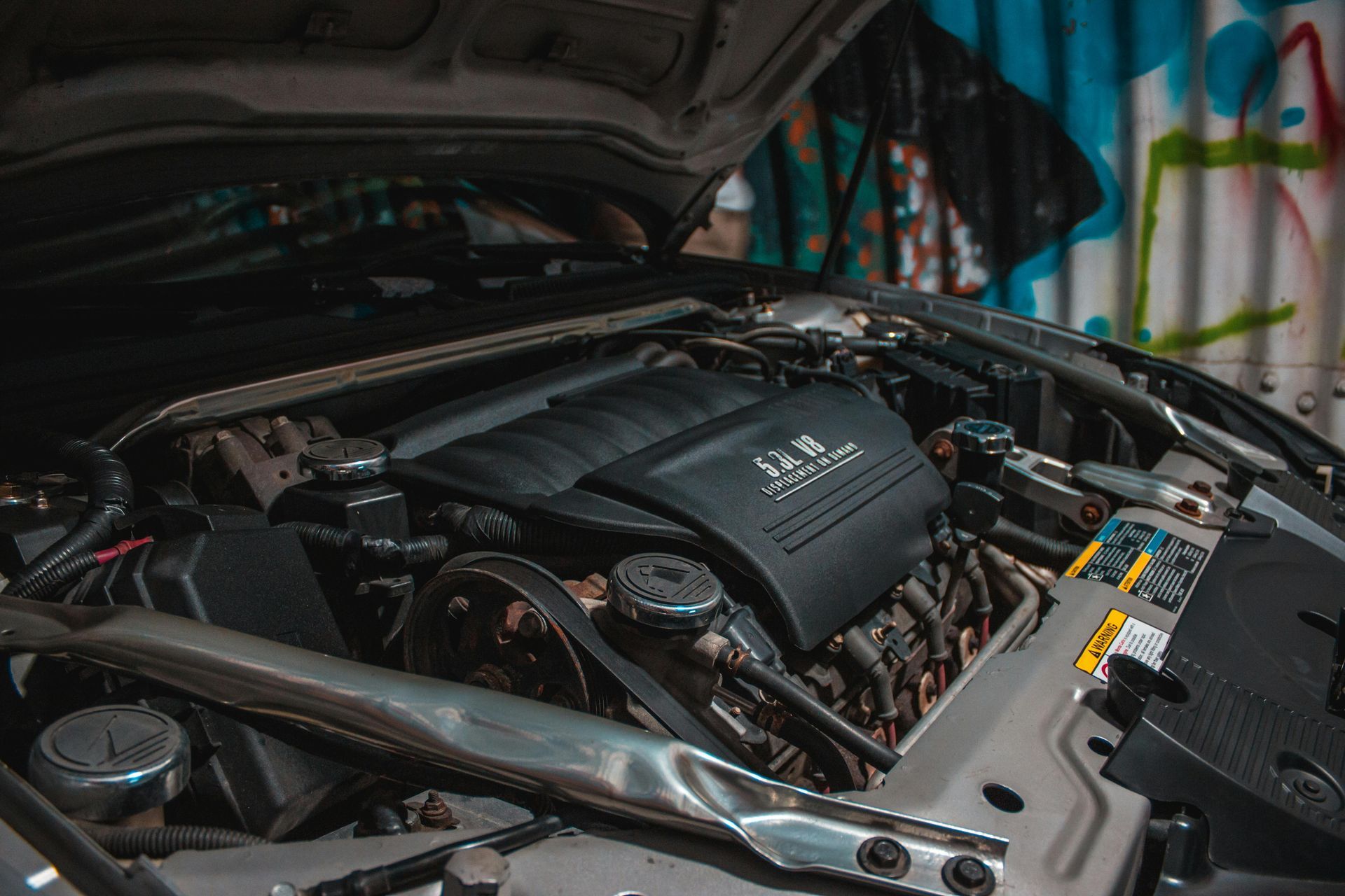The engine of a car is shown with the hood open.