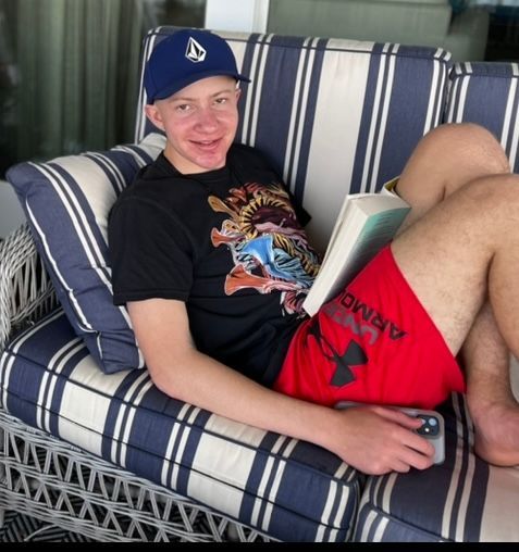 LBF Hero Ben on the couch reading