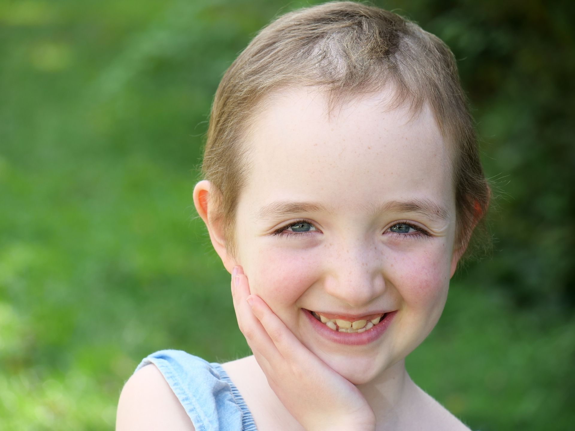 Kasey smiling with hand on her cheek
