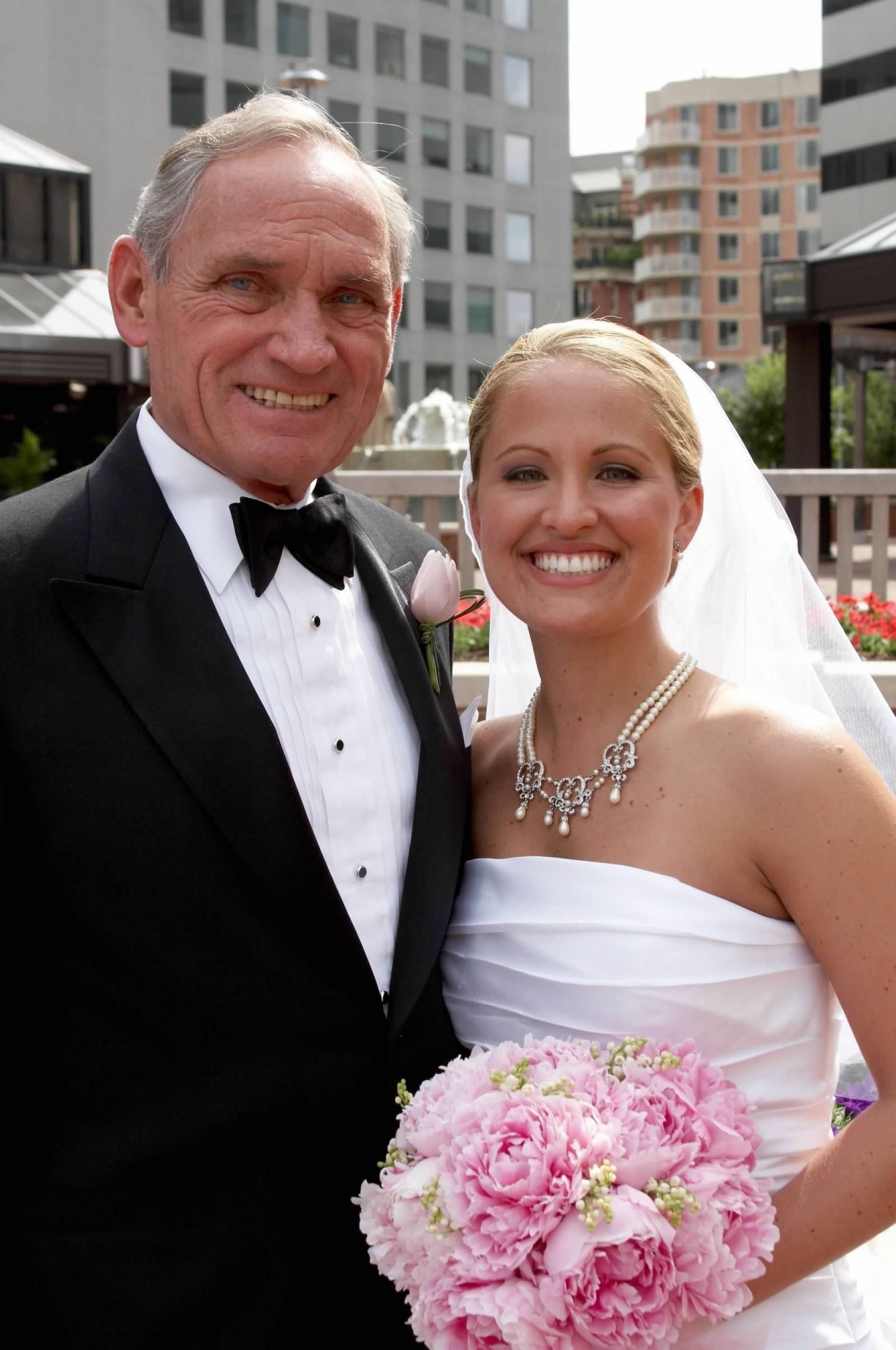 Kelly Barch in her wedding dress with her dad in a tux